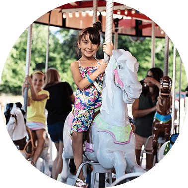 Guest Smiling On Merry Go Round